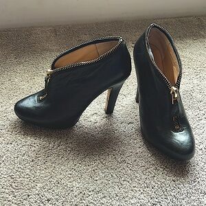 Diane von Furstenberg black leather bootie with gold zip details. Truly unique!